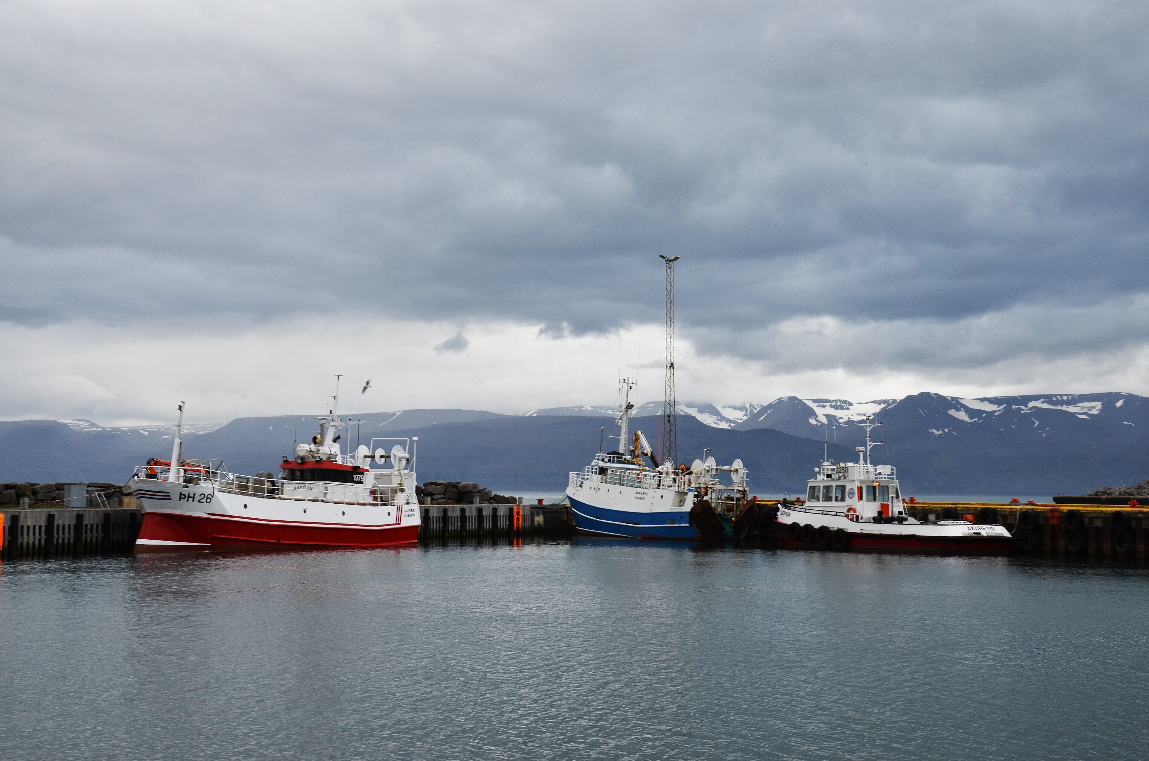 Húsavík harbour on Skjálfandi, with the wooden church above the waterfront